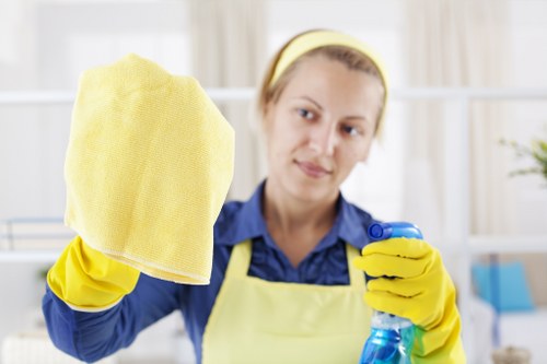 Cleaner wearing PPE while working in a property